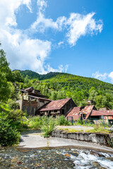 Old Bocard d'Eylie mine in Sentein - Dilapidated buildings in a mountainous Pyrenean settingLush waterfall cascading over moss-covered rocks