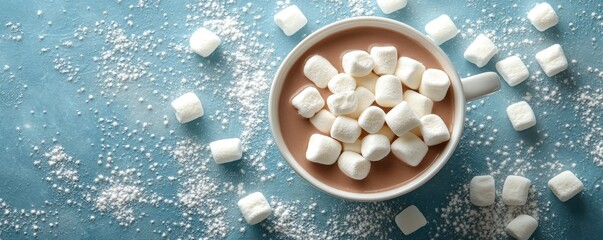 Hot chocolate cup surrounded by mini marshmallows, winter theme, blue background, close-up