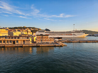 Naklejka premium A large cruise ship docked at a harbor during golden hour in Ancona, Italy