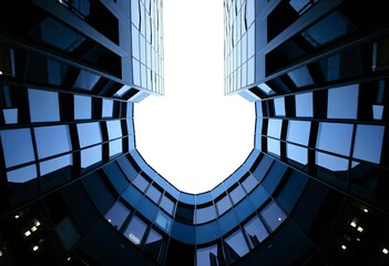 Obraz premium Looking Up modern high-rise office buildings with blue sky in the background, ai