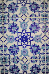 Traditional Turkish ceramic tiles, closeup photo of decorative, vintage, blue, cyan, historic tiles on the wall in Turkey (Türkiye)