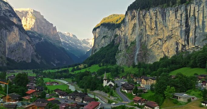 Aerial view of the beautiful village Lauterbrunnen with Staubbach waterfall. Mountain Jungfrau at the background. Picturesque Swiss valley of Lauterbrunnen, green alpine valley in Switzerland