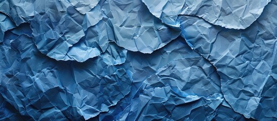 Fototapeta premium Denim colored painted paper texture serves as an abstract blue background with copy space image