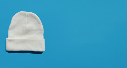 a white, warm, winter hat. knitted human headdress. an element of the wardrobe. background for the design.