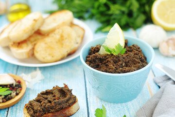 A bowl with tapenade - traditional olive dip in Mediterranean region