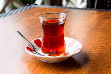 side view of turkish tea in small glass on saucer