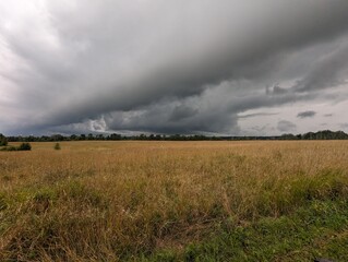 Clouds over a beautiful farm field in the countryside.