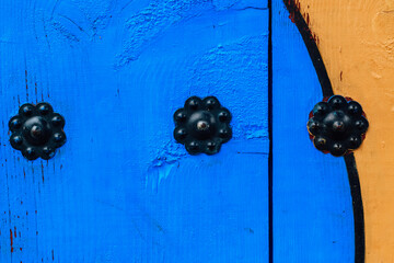 decorative wooden elements on an old gazebo and shaped metal rivets