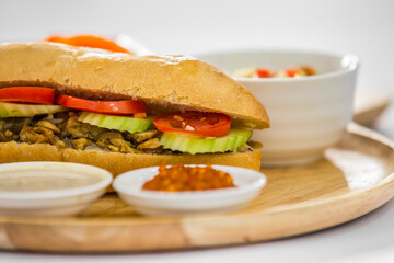 sandwich shawarma chicken in a baguette middle eastern food salad and pickles  israeli food restaurant menu day time