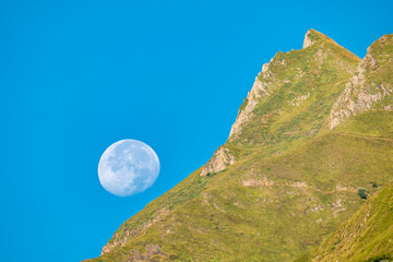Full Moon Over a Mountain Peak