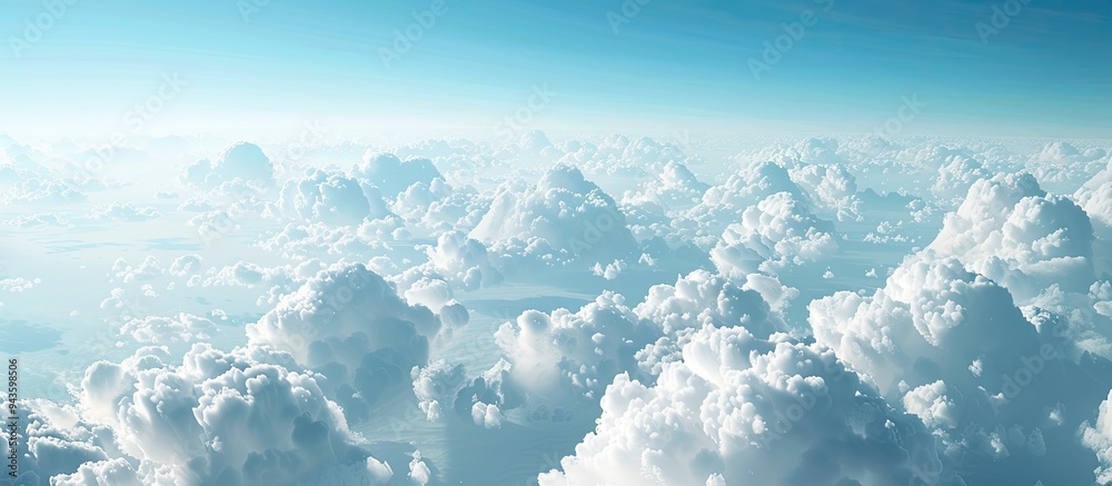 Aufkleber scenic aerial view with serene white clouds against a clear blue sky visible through a plane window 