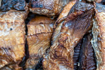 Close-up view of dried fish with rich textures and warm tones, highlighting their natural hues.