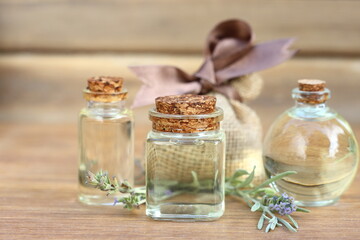 lavender essential oil in glass bottle on wooden background