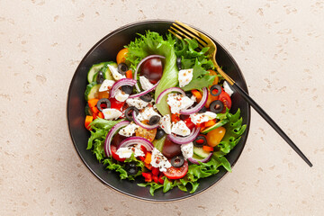 Greek salad of fresh cucumber, tomato, sweet pepper, red onion, feta cheese and olives with olive oil. Healthy food. Top view