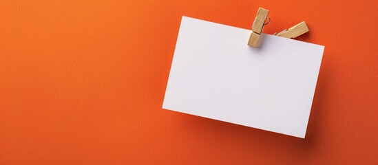 Business Growth portfolio concept displayed on elegant white paper clipped on a wooden clothespin against a lovely orange background with a copy space image
