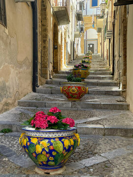 spring in Sicily Taormina Italy alley with stairs leading up filled with colorful flower pots. vacation spot