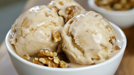 Walnut ice cream scoops in a glass.