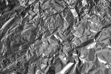 Processed collage of shiny metal silver gray foil crumpled packaging material texture