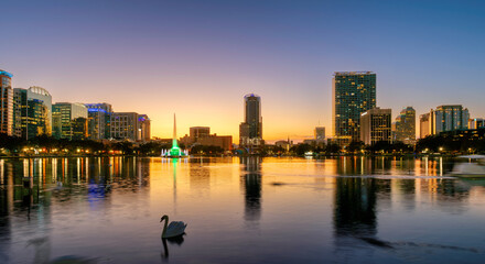 Fototapeta premium Orlando skyline lit at sunset. Panoramic view of Orlando city in Lake Eola, Florida, USA