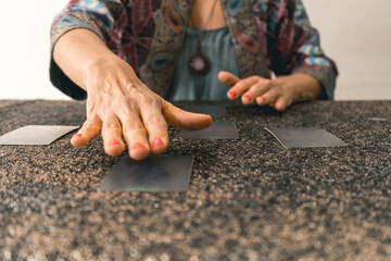 Tarot reader preparing to reveal the cards, building anticipation for the reading.