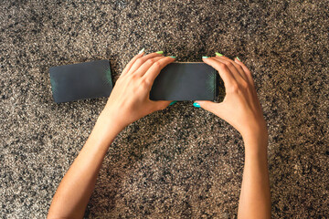 Top view of a client's hands cutting the tarot deck in three parts.