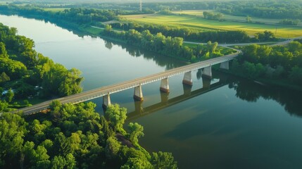 Obraz premium Aerial image of a bridge spanning a wide river, showing the completed civil engineering marvel