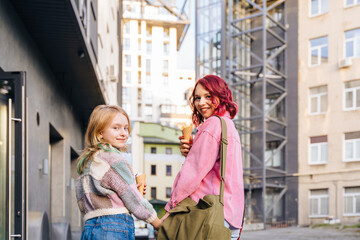 Fototapeta premium Multicolored mother and daughter walking together