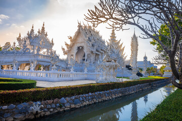 Naklejka premium Beautiful and amazing white temple at Wat Rong Khun at sunset time Chiang Rai, Thailand It is a tourist destination. Landmark of Chiang Rai