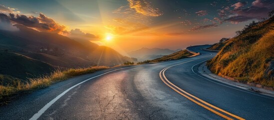 Naklejka premium Asphalt highway with an empty curved road featuring clouds and the sky at sunset. with copy space image. Place for adding text or design