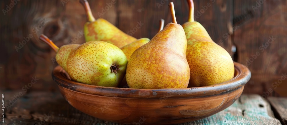 Poster ripe pears in a bowl on a wooden table. with copy space image. place for adding text or design