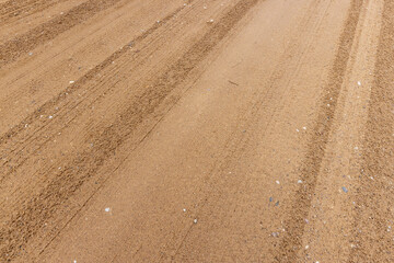 Naklejka premium close-up of a part of a wet road without asphalt