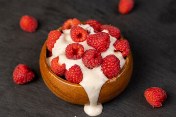 delicious and fresh yogurt with raspberry flavor and whole red raspberries
