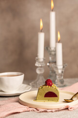 A piece of pistachio cake-ice cream on plates, candlelit dessert, Valentine's Day, New Year, Christmas