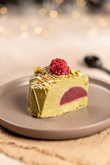 A piece of pistachio cake-ice cream on plates, candlelit dessert, Valentine's Day, New Year, Christmas