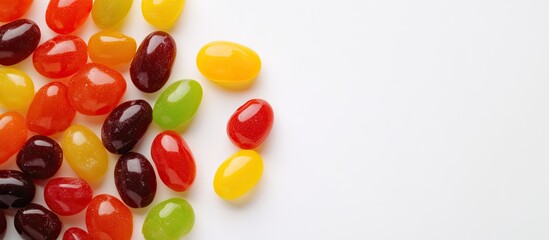 Bright vibrant photograph of jelly bean candies taken from above on a white background with copy space