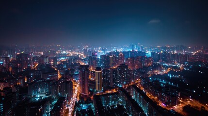 Obraz premium A panoramic nighttime cityscape from a tall building, highlighting the beauty and energy of urban lights
