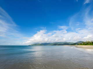 A sunlit cloudscape over sea and mountain