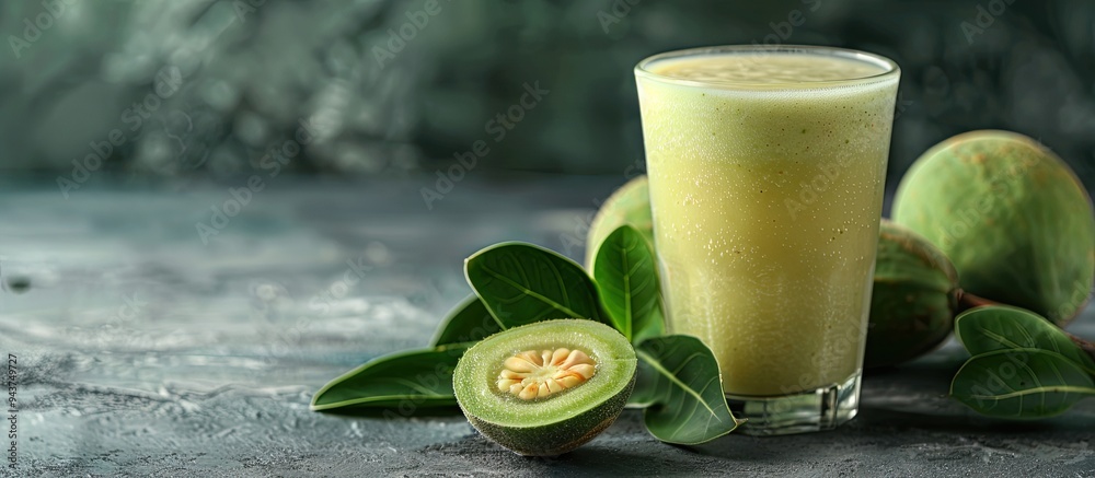 Leinwandbilder fresh feijoa smoothie in a glass on a gray table close up with room for text. with copy space image.