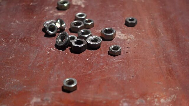 Some nut of screw were dropped on the wood