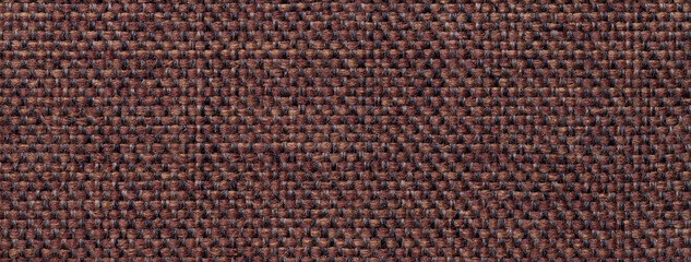 Texture dark brown background from woven textile with wicker pattern, macro. Structure of vintage umber fabric cloth,