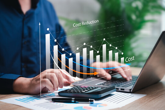Cost management, Cost reduction concept, Businessman use laptop to analyse profit, Graph cost control and high quality of product optimize manufacturing, Decreasing company expenses to maximize profit