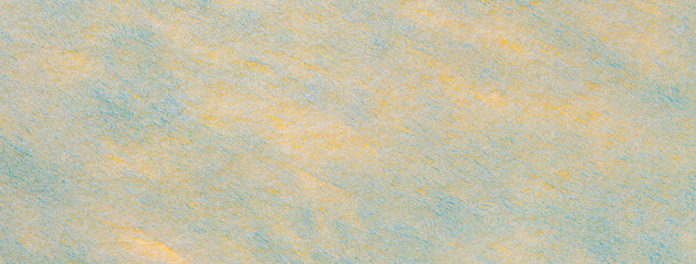 Texture of light yellow and blue felt background with spots of fabric, macro. Structure of woolen textile