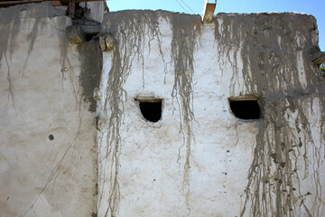 a wall made of white clay with streaks of dirt on top
