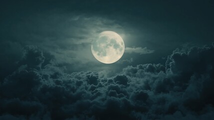 The moon glowing behind the moving clouds