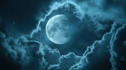 The moon glowing behind the moving clouds