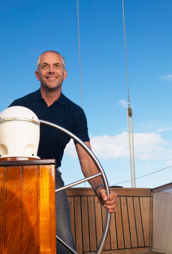 Man Steering Boat