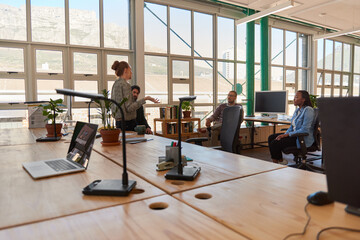 Businesswoman talking with diverse colleagues during a casual office meeting