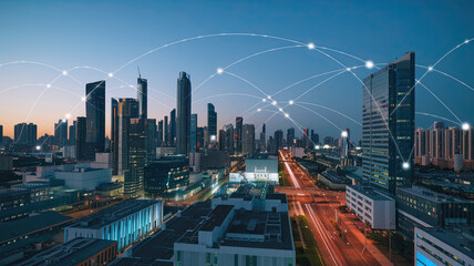 Obraz premium Smart city digital transformation concept with band lights over a modern urban cityscape at night, highlighting 5G technology and fiber optics for fast internet communication
