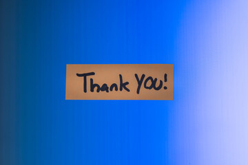 A thank you note on a computer screen. The note is on a blue screen background with a heavy vignette