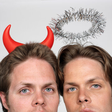 Portrait of Twin Brothers Dressed Like Devil and Angel